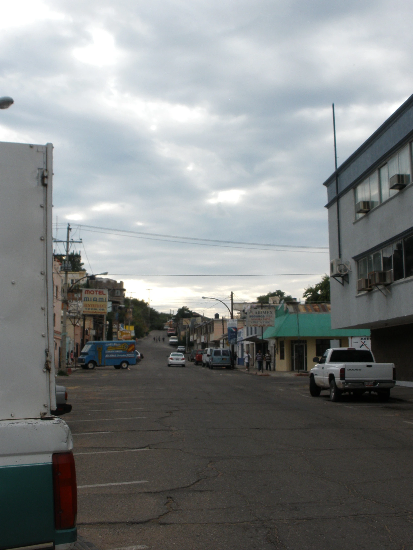 a white truck parked on the street next to a building