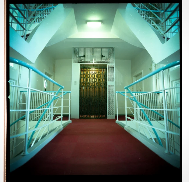 stairs lead up to a door in a hallway