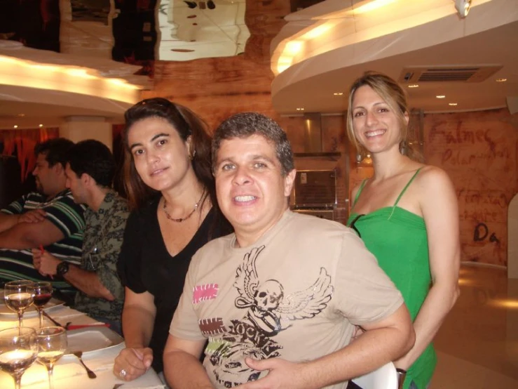 two women and two men in front of a table with wine glasses