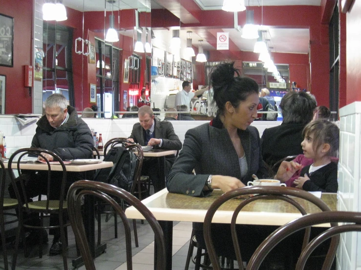 an older woman at a table in a restaurant with a younger girl