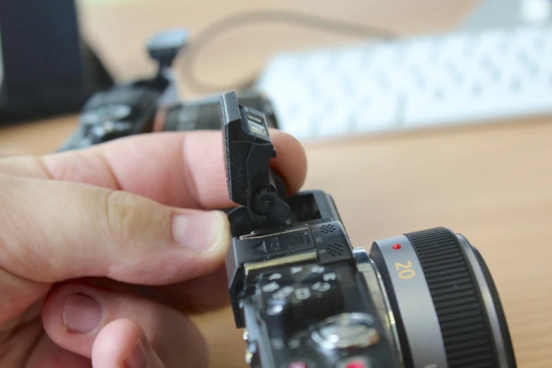 a camera being held with one hand and another using the other