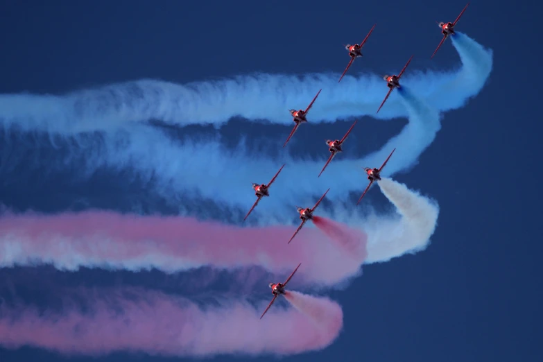 airplanes releasing smoke into the sky in formation