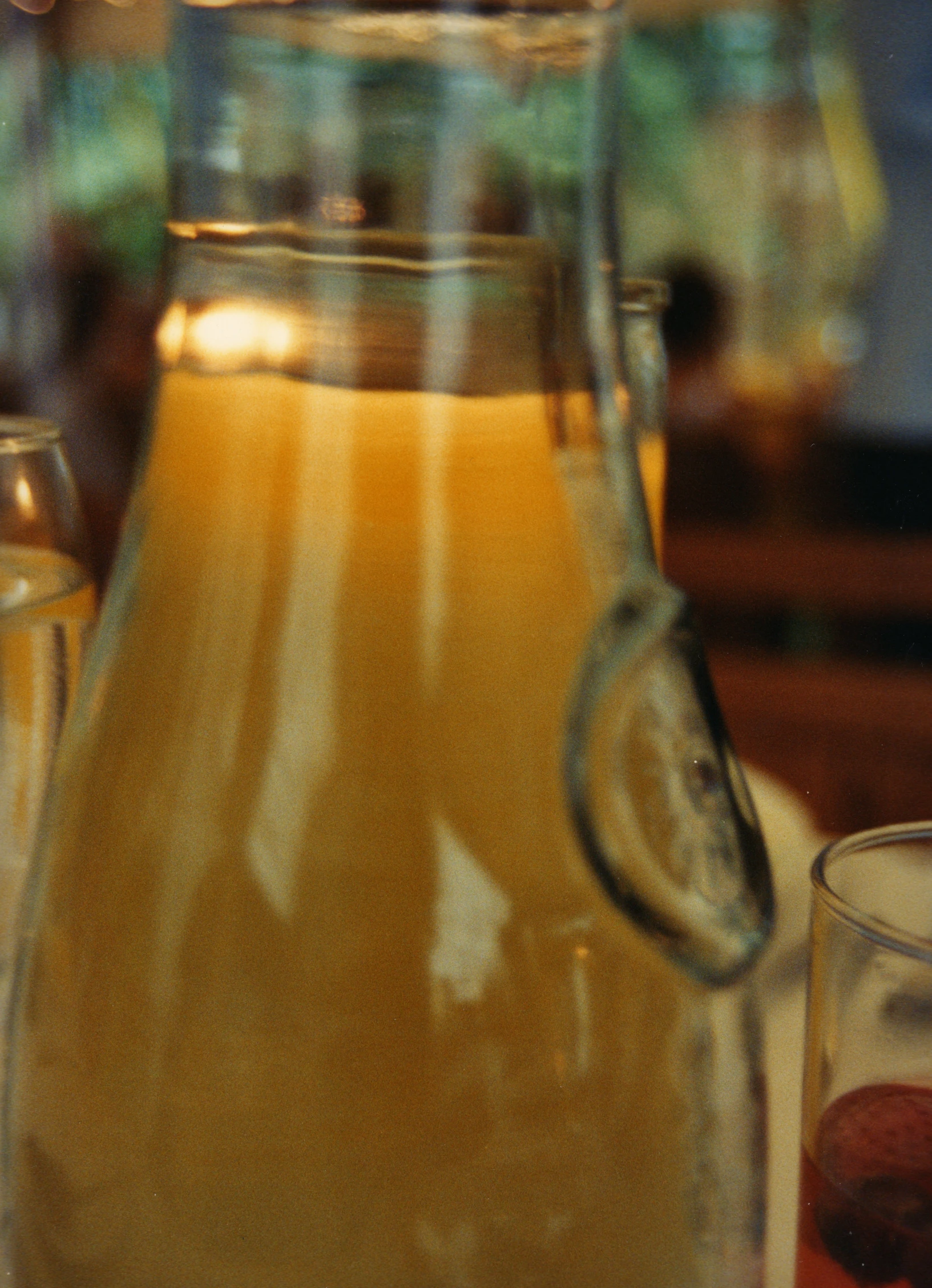 a pitcher and two glasses of juice sitting on a table