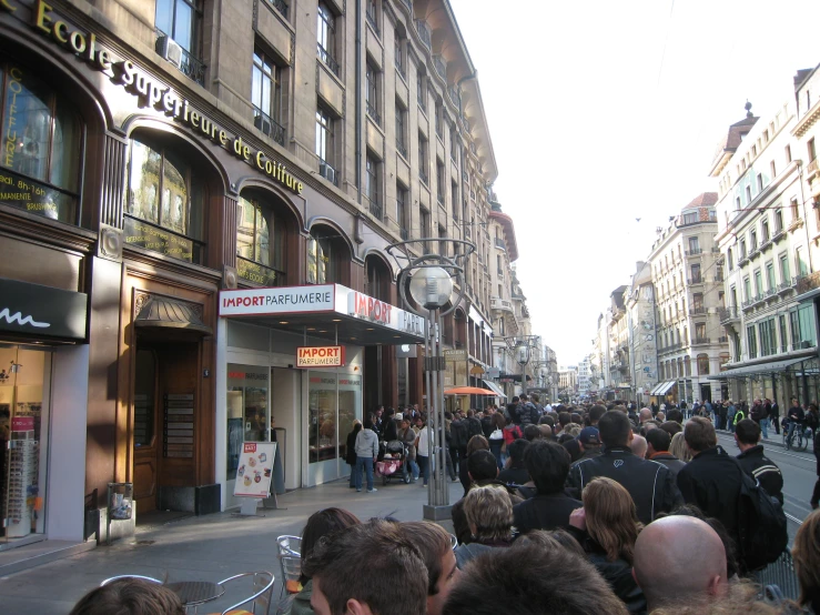 a city street that has a bunch of people walking down it