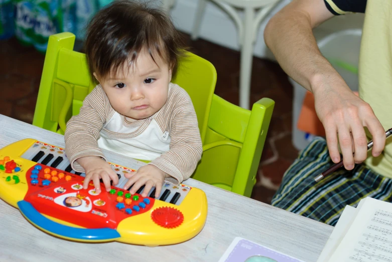 a small baby sitting at a table