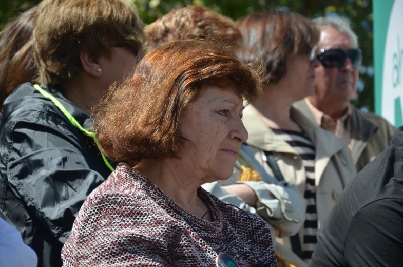 an older woman sitting next to a younger man at an event