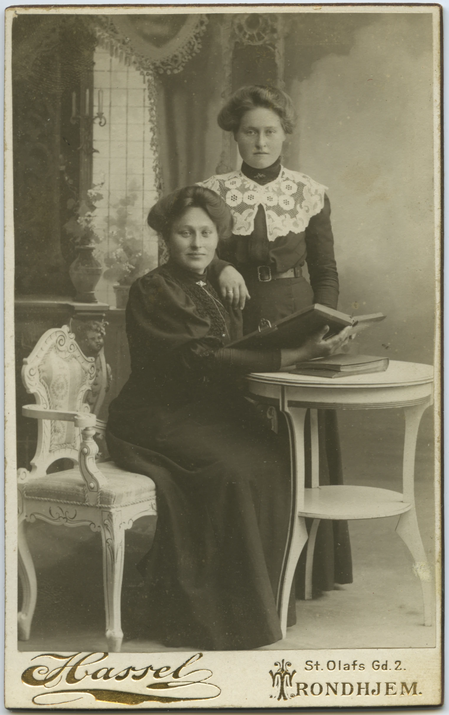 an old fashioned black and white pograph of two women