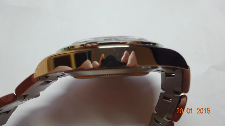 an electronic wristwatch with gold and black trim