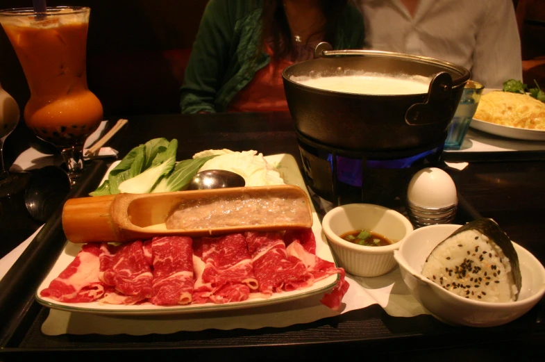 the plate with different kinds of meats is on the table