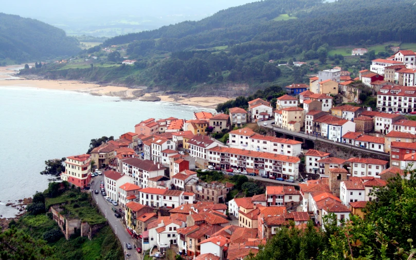 the beautiful red roofs of a city beside the ocean