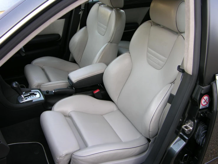 a car interior with all white leather seats