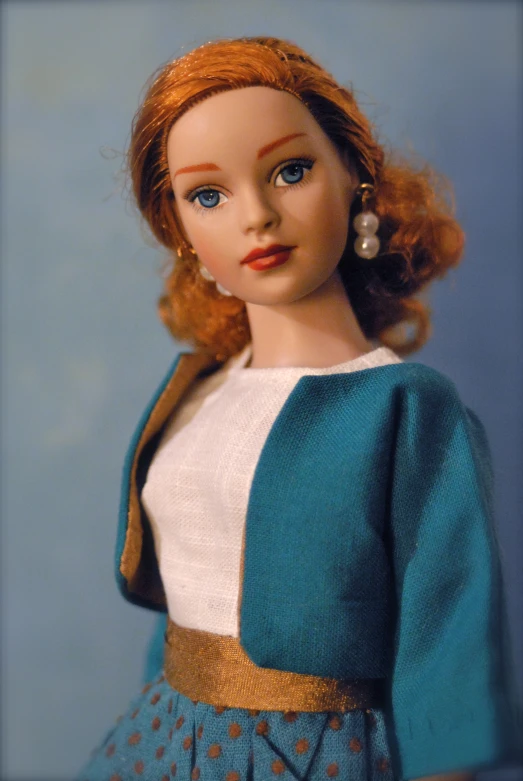 a doll wearing a dress with brown spots on the skirt