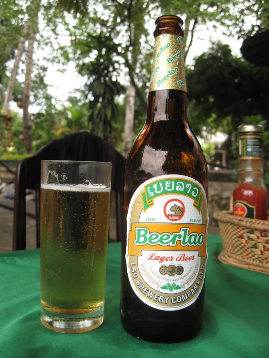 a bottle of beer sits next to a glass of beer