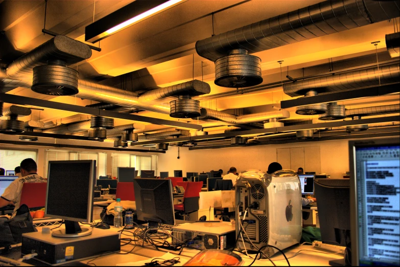 a room full of people sitting at their computer monitors