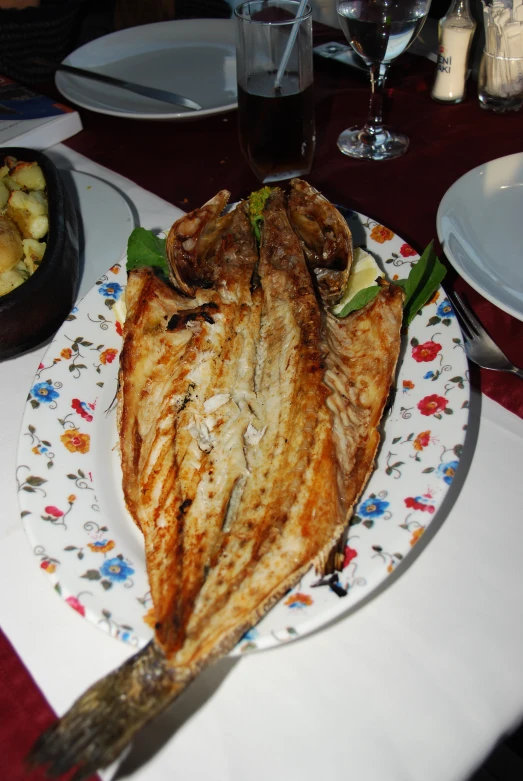 a large fish is on the plate ready to eat
