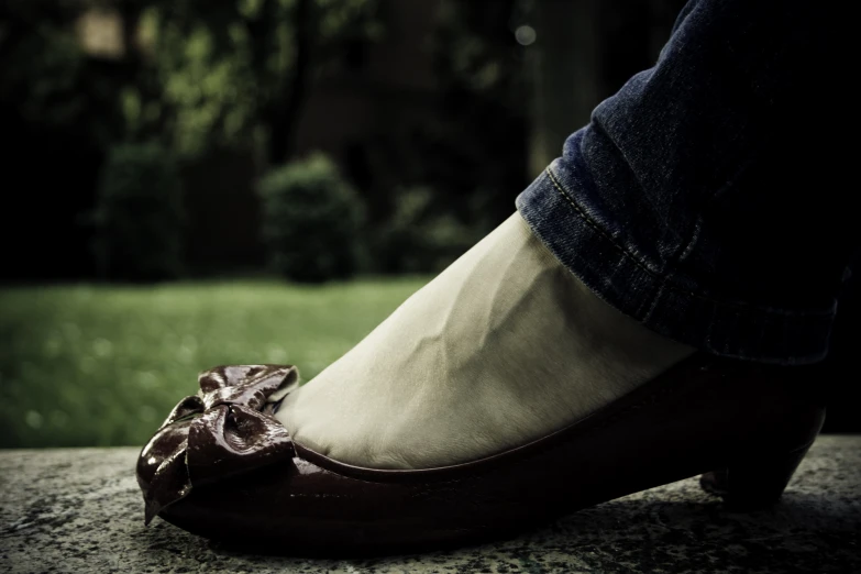 a close up view of a person's shoe with an object in the bottom part