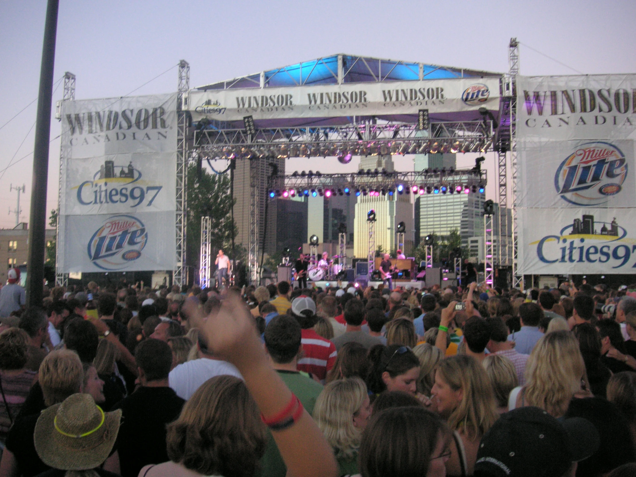 an outdoor concert is being watched by large group of people