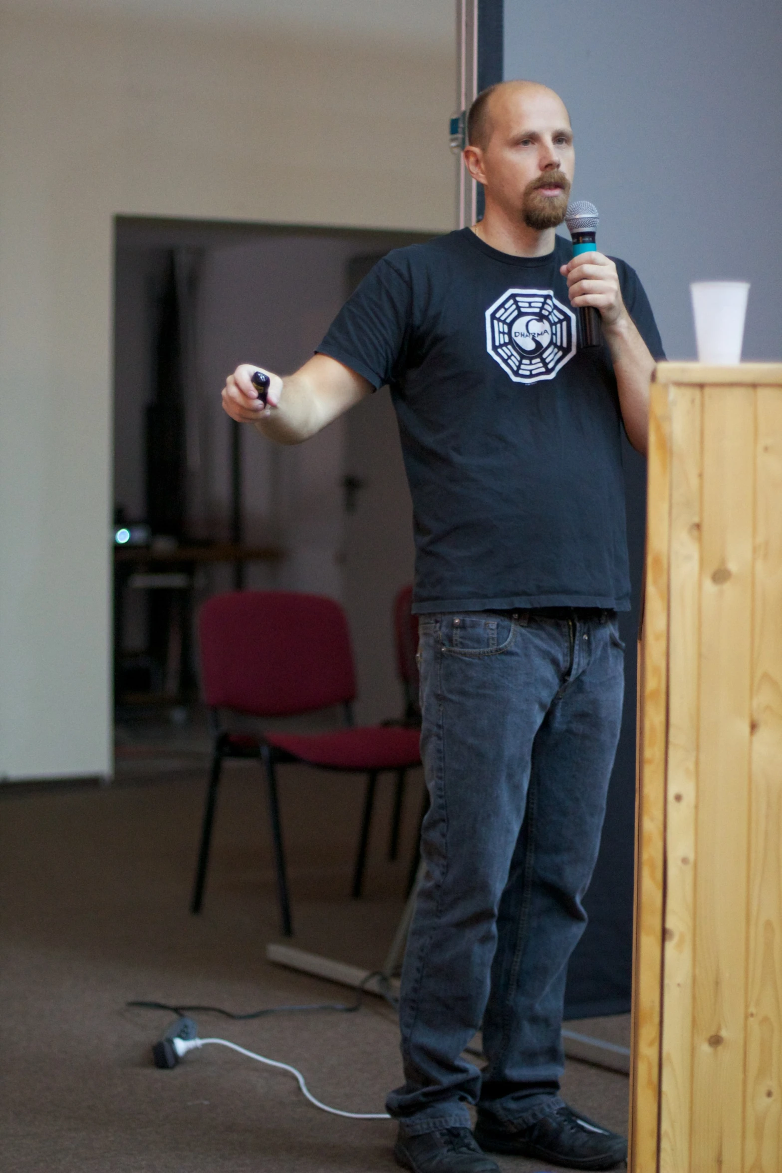 a man with a microphone is standing in front of a podium