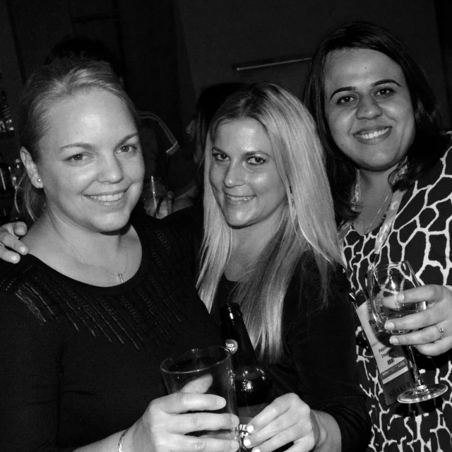 four women pose for a po with their glasses