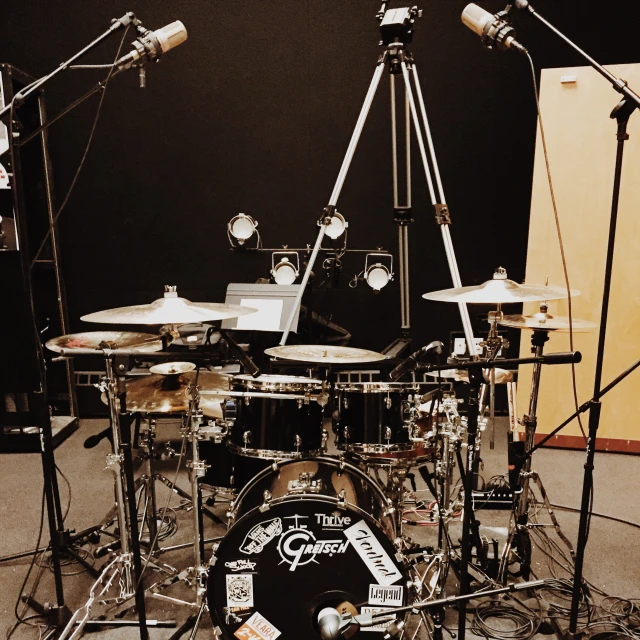 a drum kit sitting next to other musical equipment