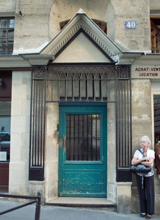 a women standing in front of an old building