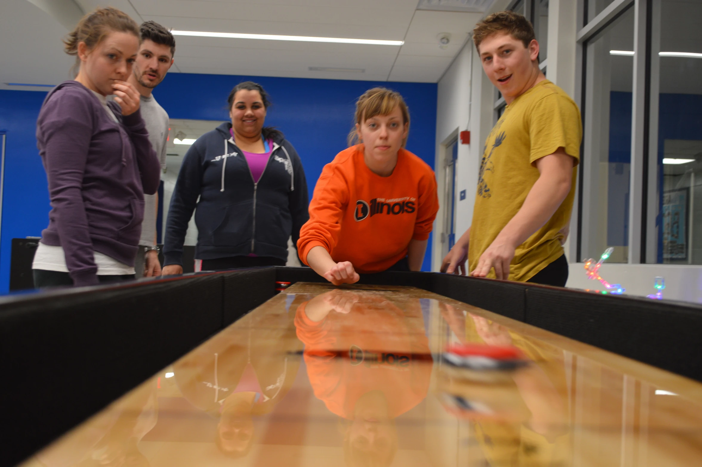 group of men and women in a bowling alley