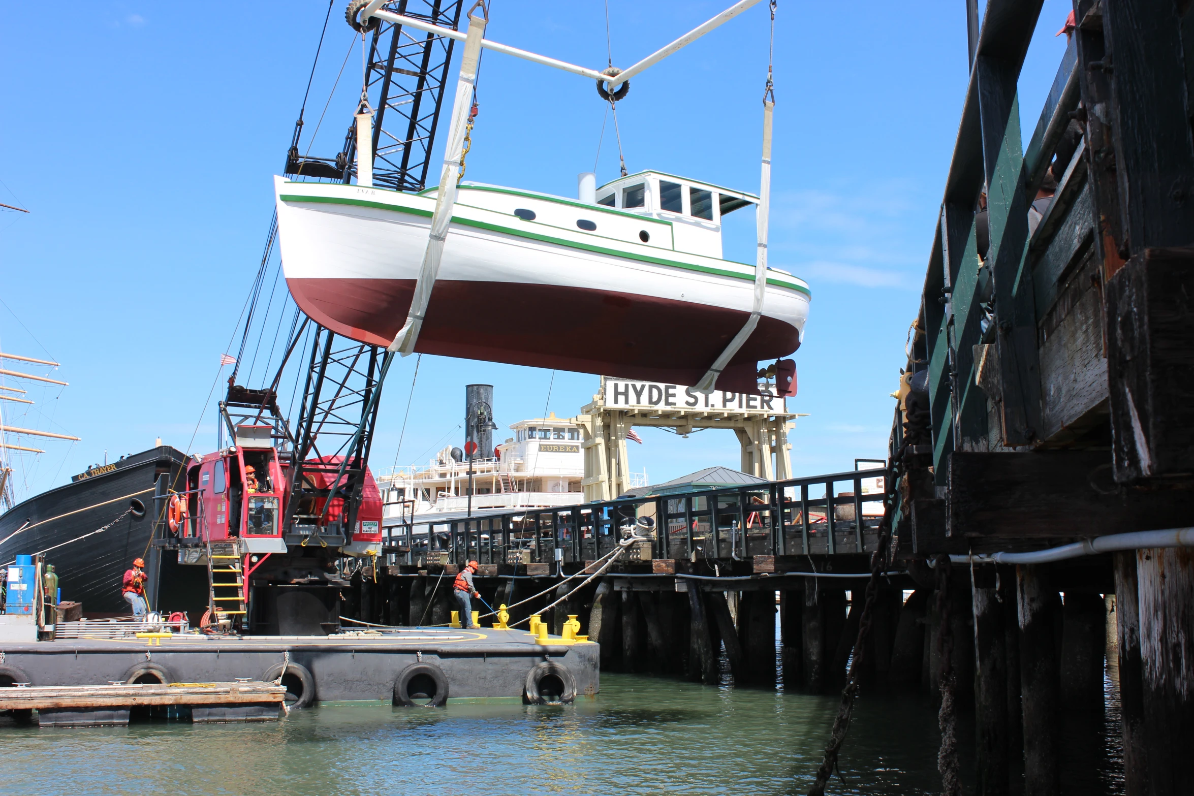 a dock with a ship in it and two boats next to it