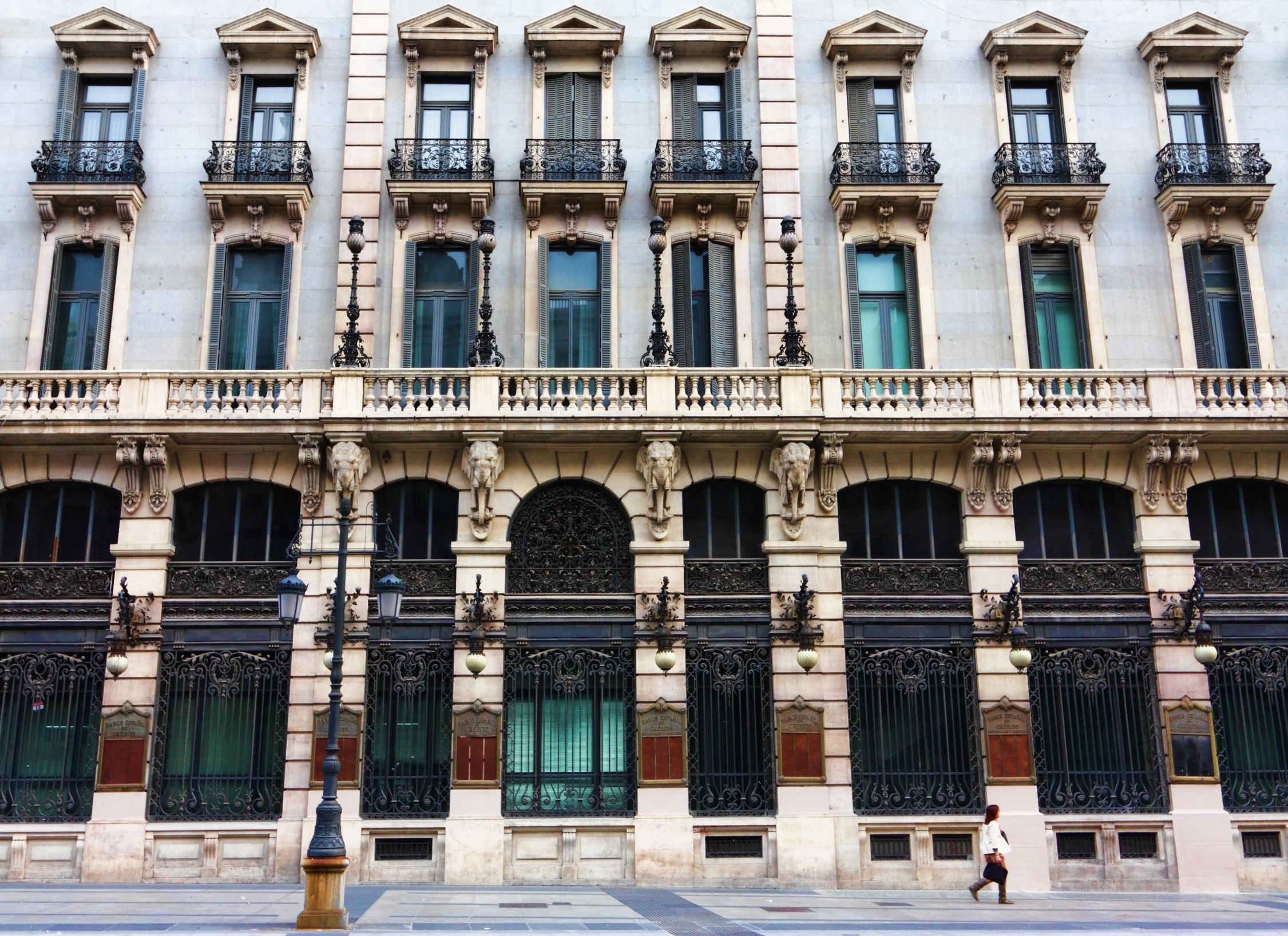 an older building with a bunch of black wrought iron fences