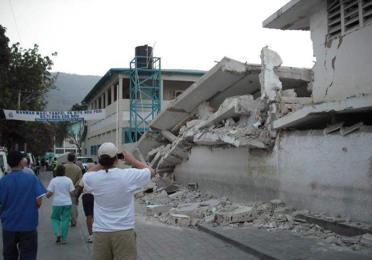 a man taking pictures of a damaged street