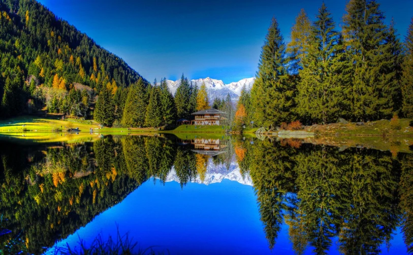 a small lake near the side of a mountain