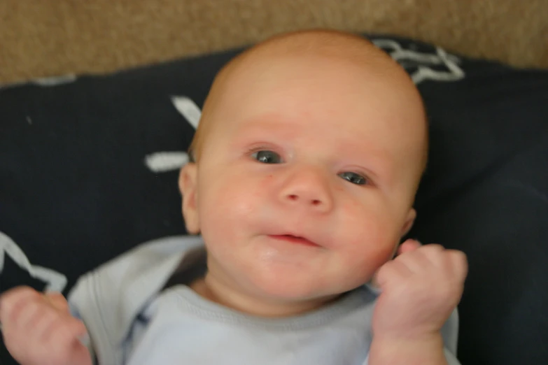 the baby is smiling in his stroller