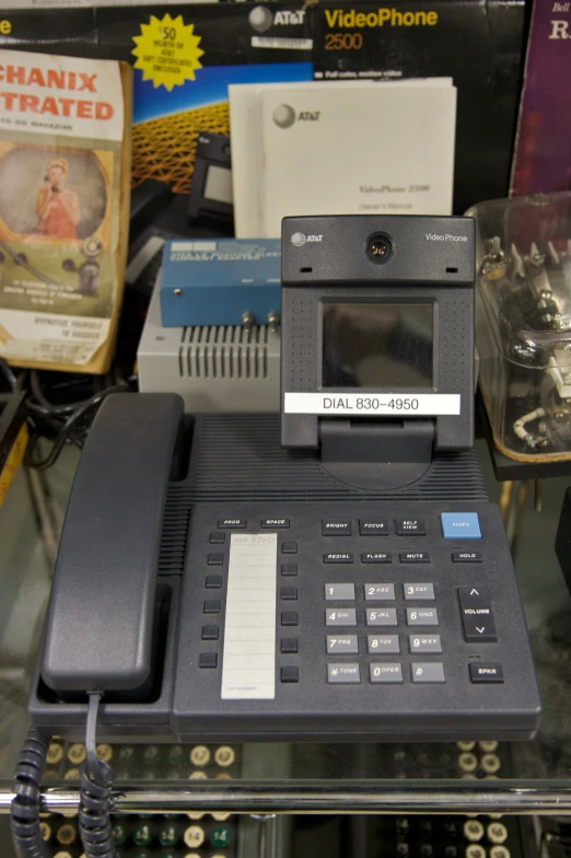 an old, black phone in a store with several other phones