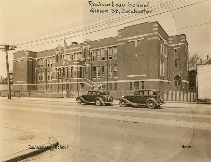 an old time po shows two cars in front of a building