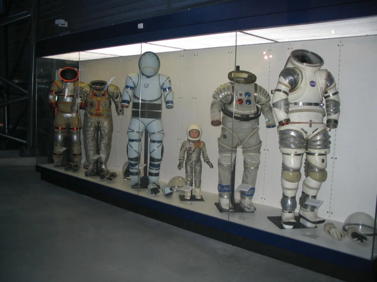 an exhibit with a bunch of space suits on display