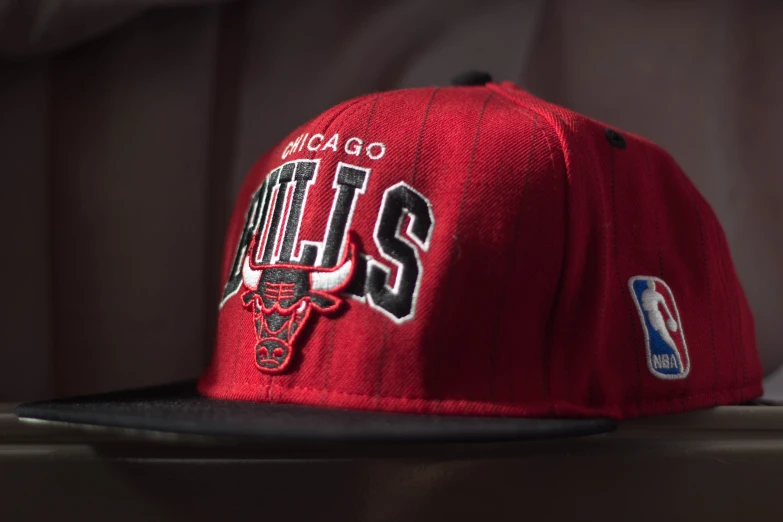 the chicago bulls'red snap back hat with the chicago bulls logo on it