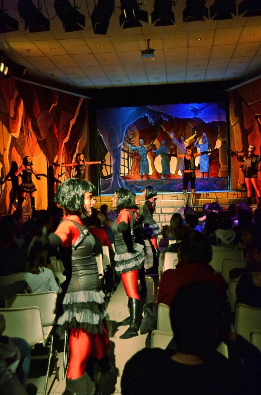 people in costume performing an elaborate performance on stage