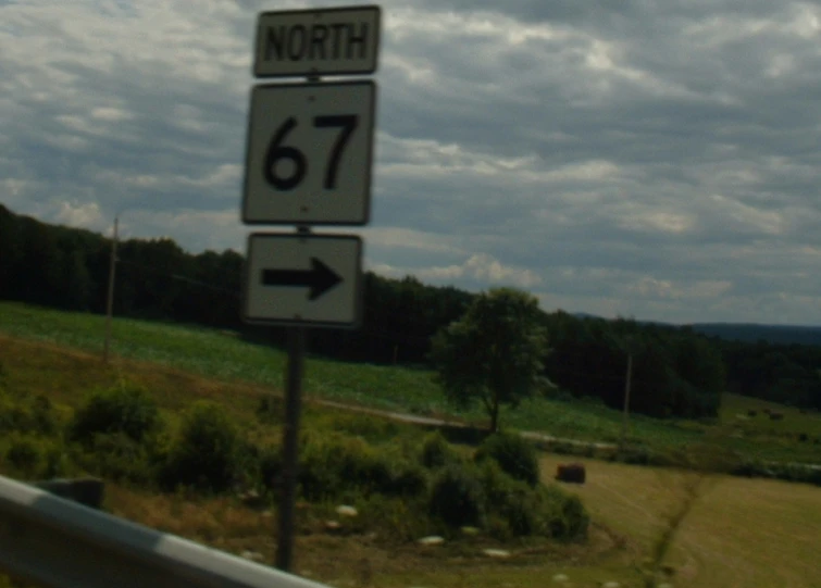 street signs that show directions for north and route 66