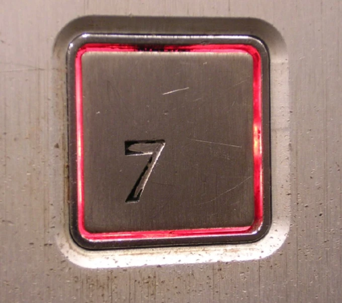 a metal plate with the number seven on it