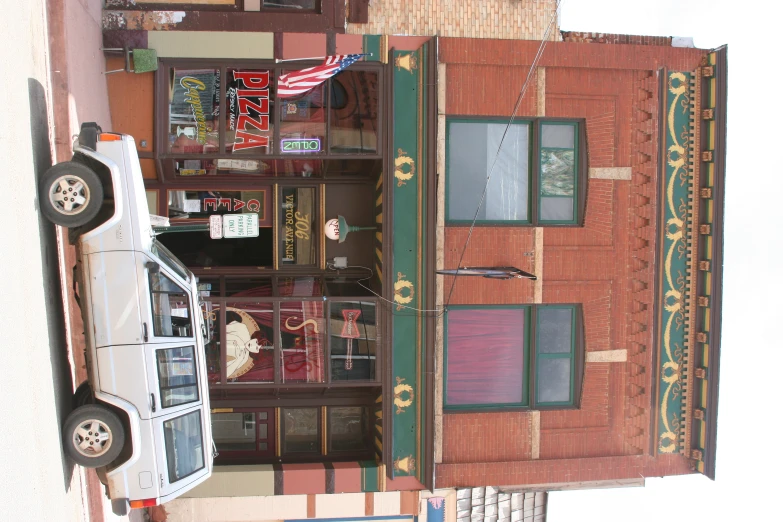 a car is parked in front of an old building