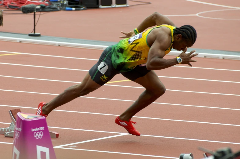 a man on a track jumps into the air