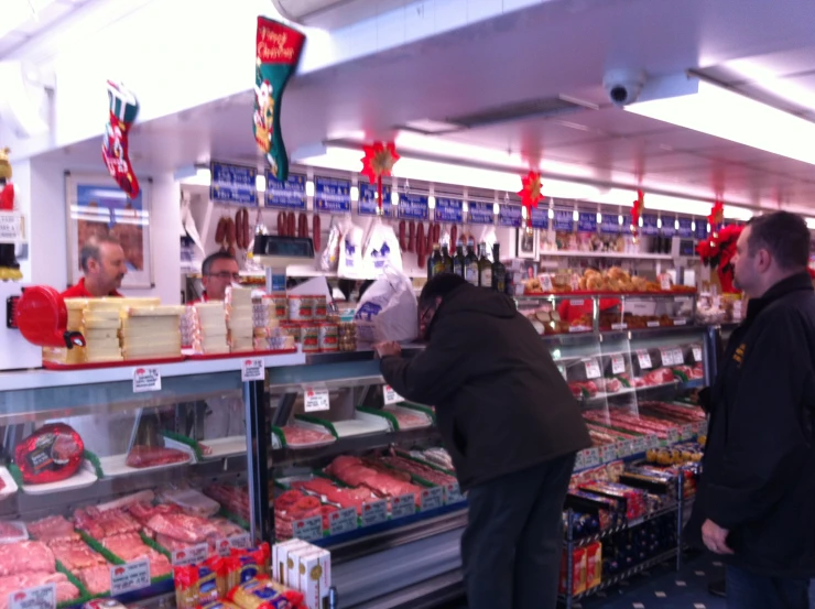 people in a grocery store shopping for food