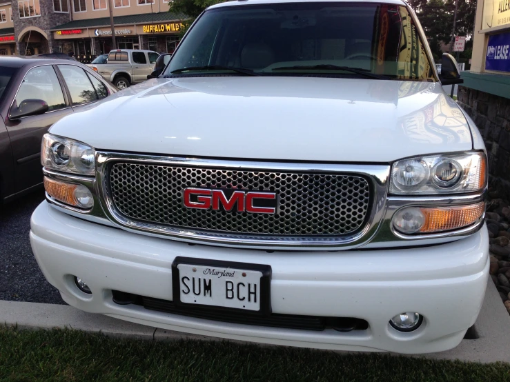 a large white truck parked next to a parking lot