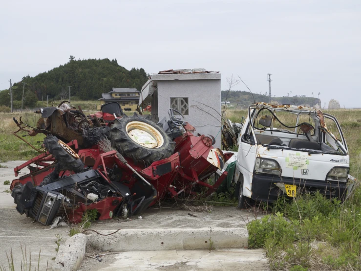 some cars that have been left on and are on a pile of junk