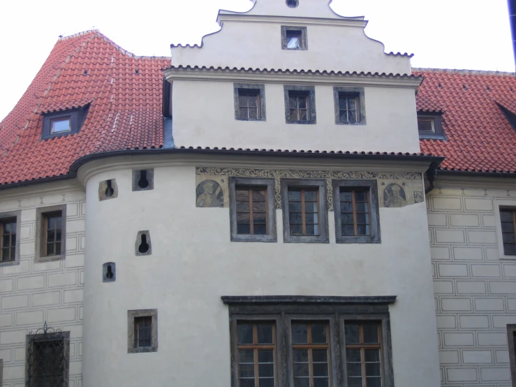 a large white building with red roof tiles