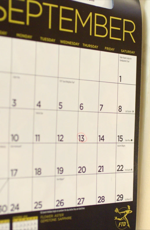 a calendar that says the day is on a white surface