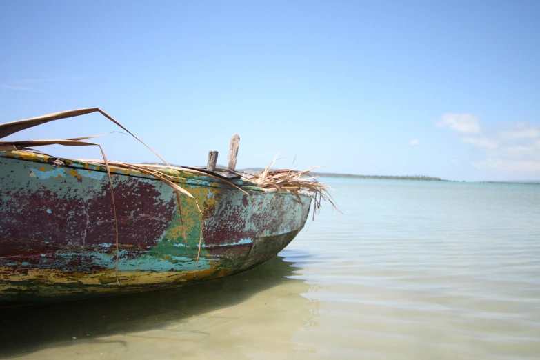 there is a rusty boat with rust in the water