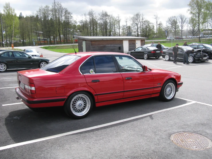 the red car is parked in the lot