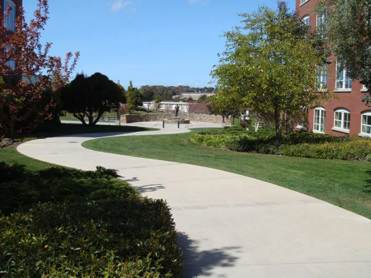 a pathway leading to a very large brick building