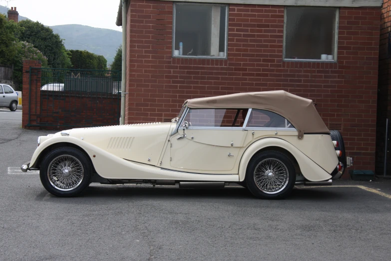 an old fashion car is parked in a driveway