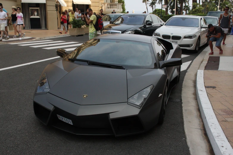 a very pretty black car on the side of a street